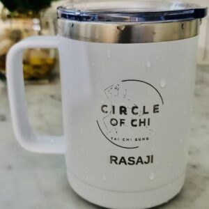 Circle of Chi Travel Mug 14oz with the logo "Circle of Chi Tai Chi Gung" and the name "Rasaji" printed on it, placed on a marble surface with droplets of water on its exterior.