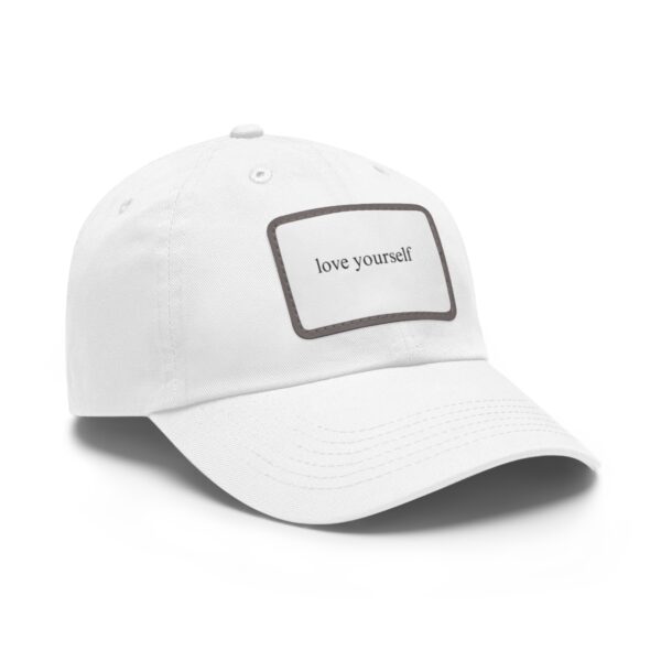 A Love Yourself Dad Hat with a rectangular patch logo in the center displaying the text "love yourself" in lowercase letters.