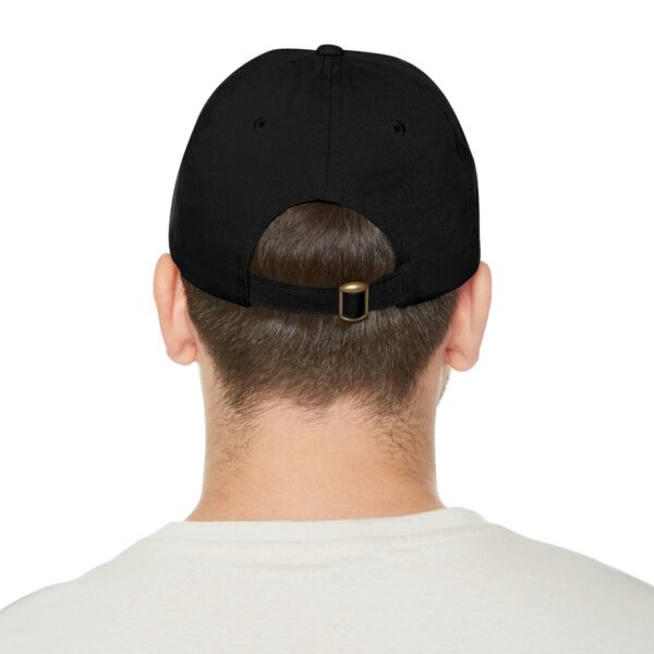 A person wearing a black Circle of Chi Dad Hat with Leather Patch and a white shirt is shown from the back.