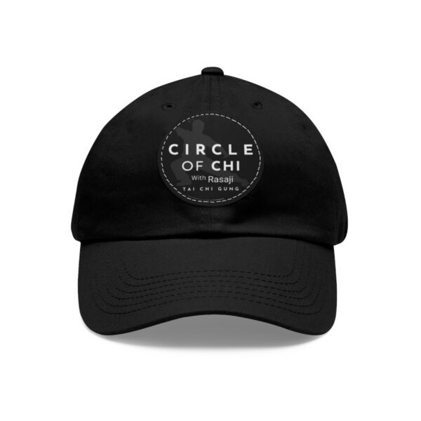 A black Circle of Chi Dad Hat with Leather Patch displaying the text "Circle of Chi with Rasaji, Tai Chi Gung" in white letters.