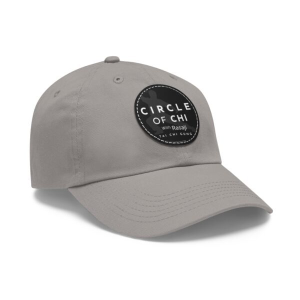 A gray Circle of Chi Dad Hat with Leather Patch featuring a round black patch on the front with the text "CIRCLE OF CHI with Rasaji TAI CHI GUNG" in white.