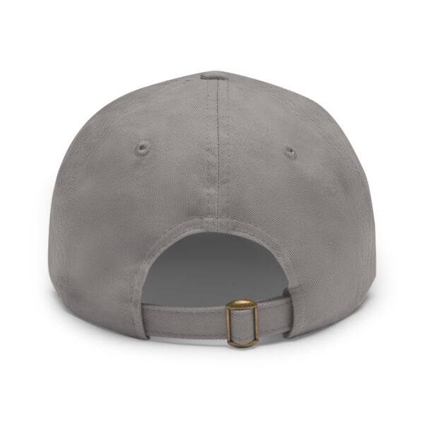 The image shows the back view of a Circle of Chi Dad Hat with Leather Patch featuring an adjustable strap with a metal buckle.