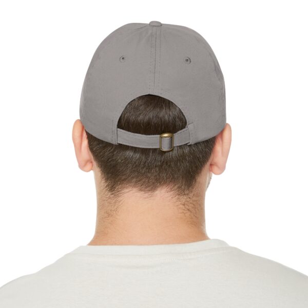 A person wearing a Circle of Chi Dad Hat with Leather Patch, viewed from behind. The individual has short brown hair and is wearing a white shirt.